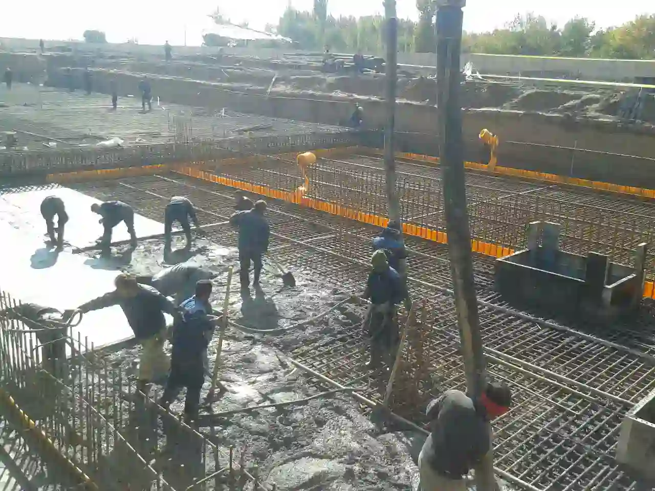 On-site concrete pouring and rebar work during wastewater treatment plant construction